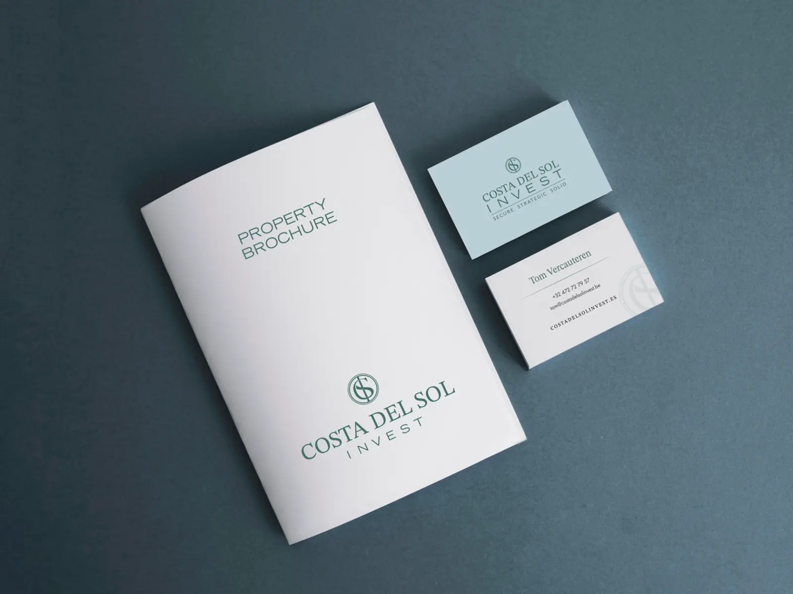 After: the new Costa del Sol Invest logo on a property brochure and business cards