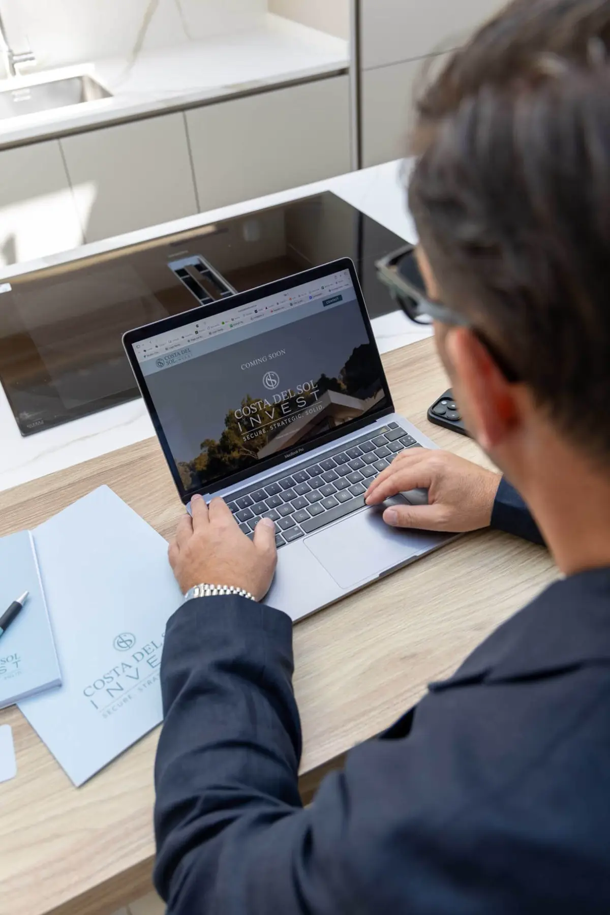 Brand shoot: working on the Costa del Sol Invest website on a laptop
