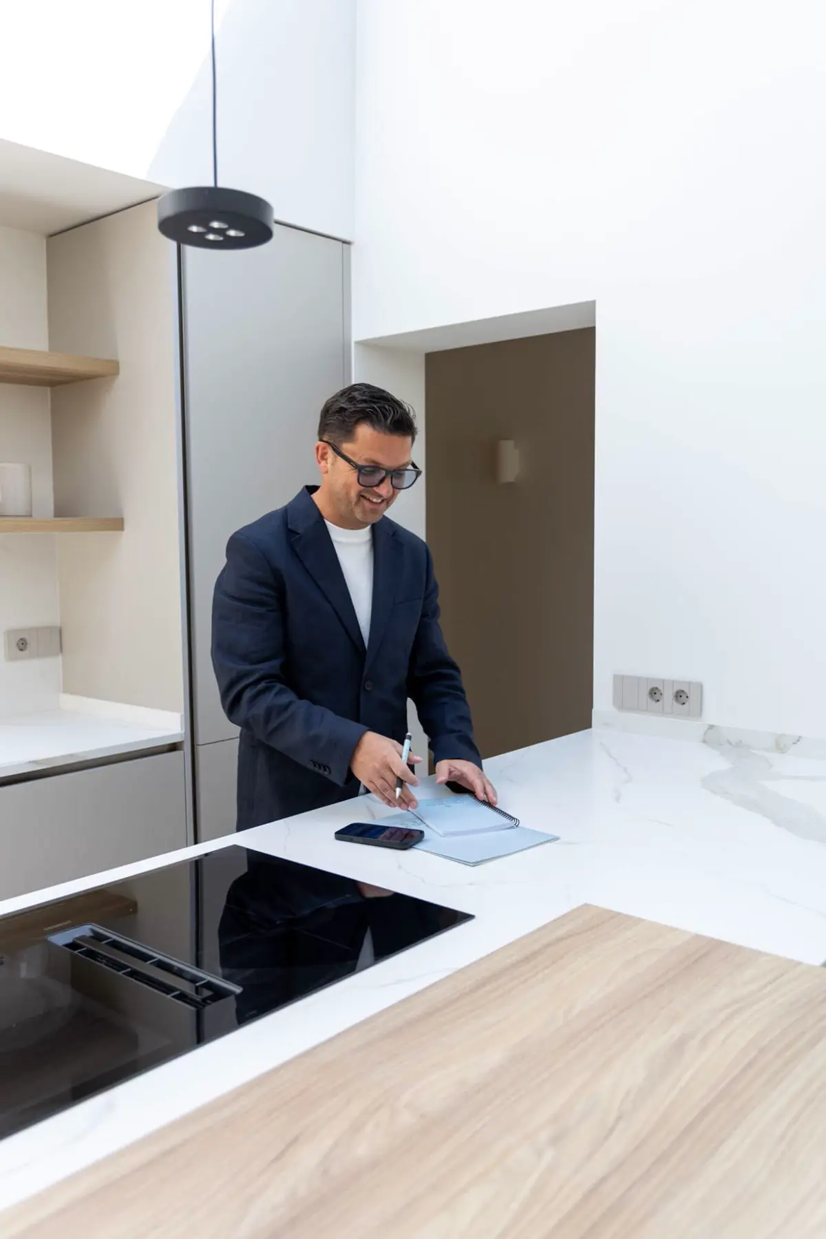 Brand shoot: reviewing notes in a modern kitchen